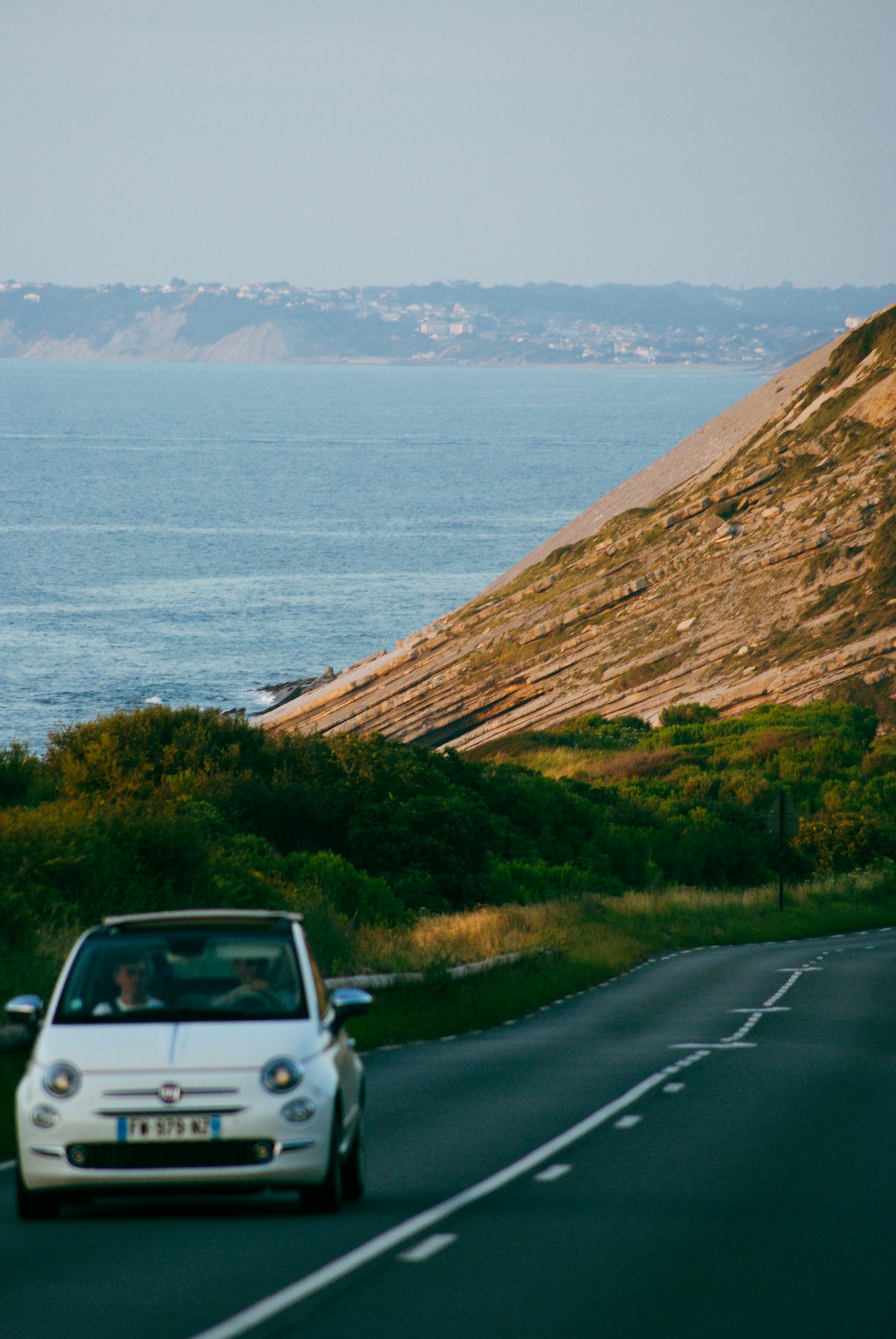Car moving along a coastal road