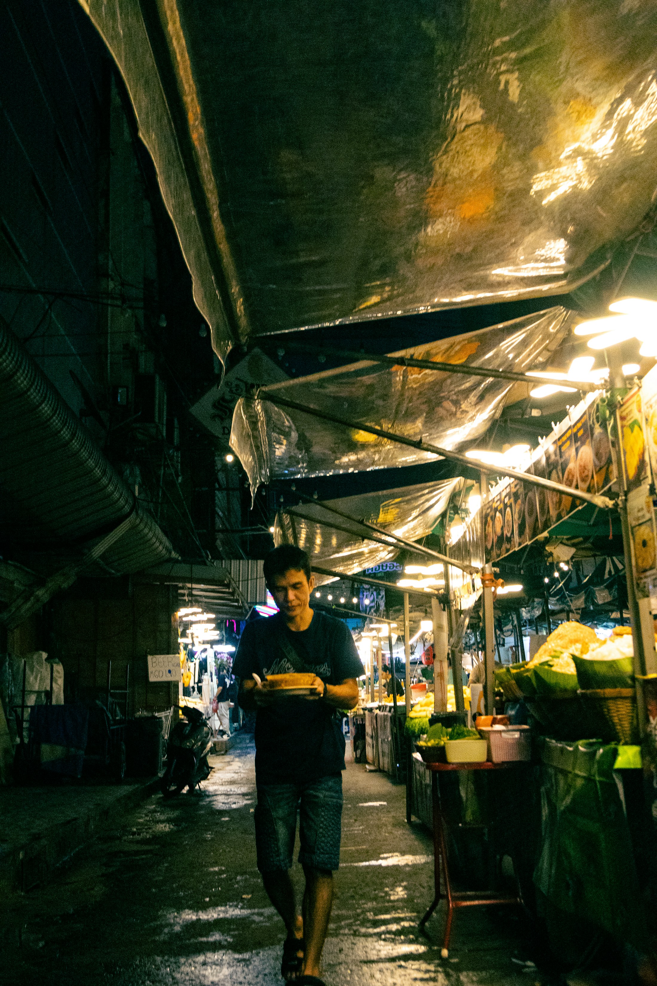 Warmly lit market lane at night