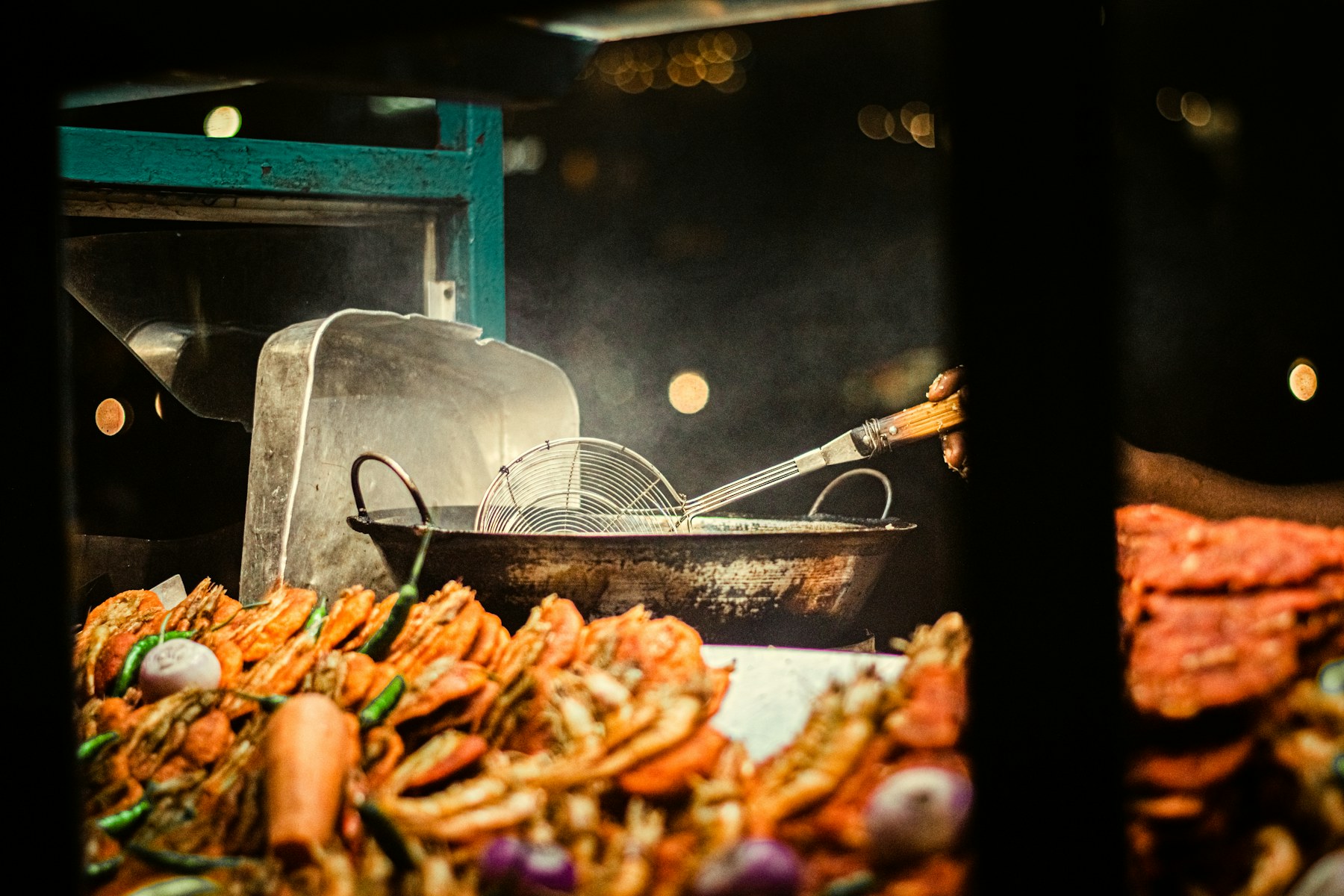 Street food being prepared under warm light